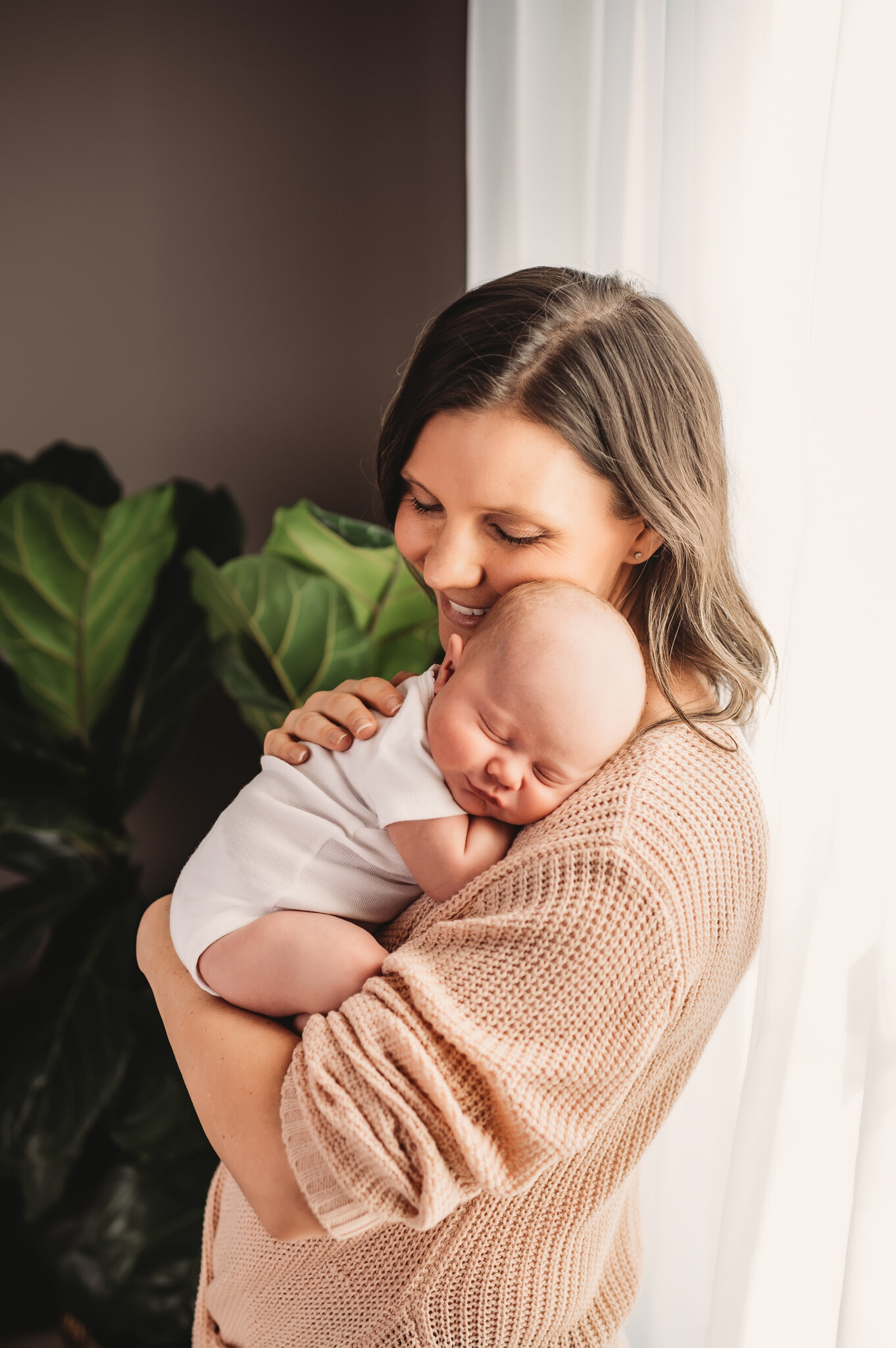 peoria newborn photographer, mom holds baby in white wrap