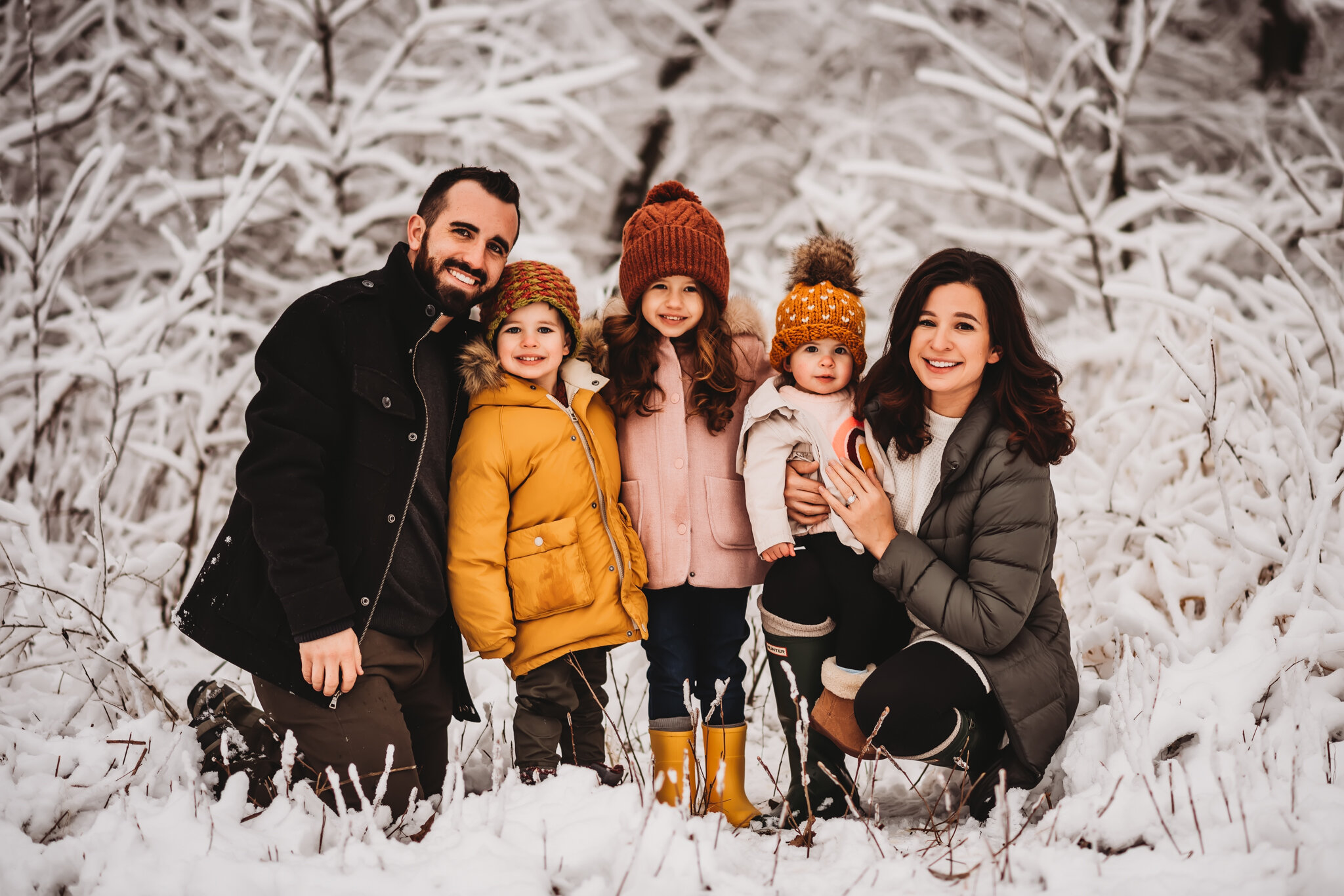 Family sits in snow family session central illinois