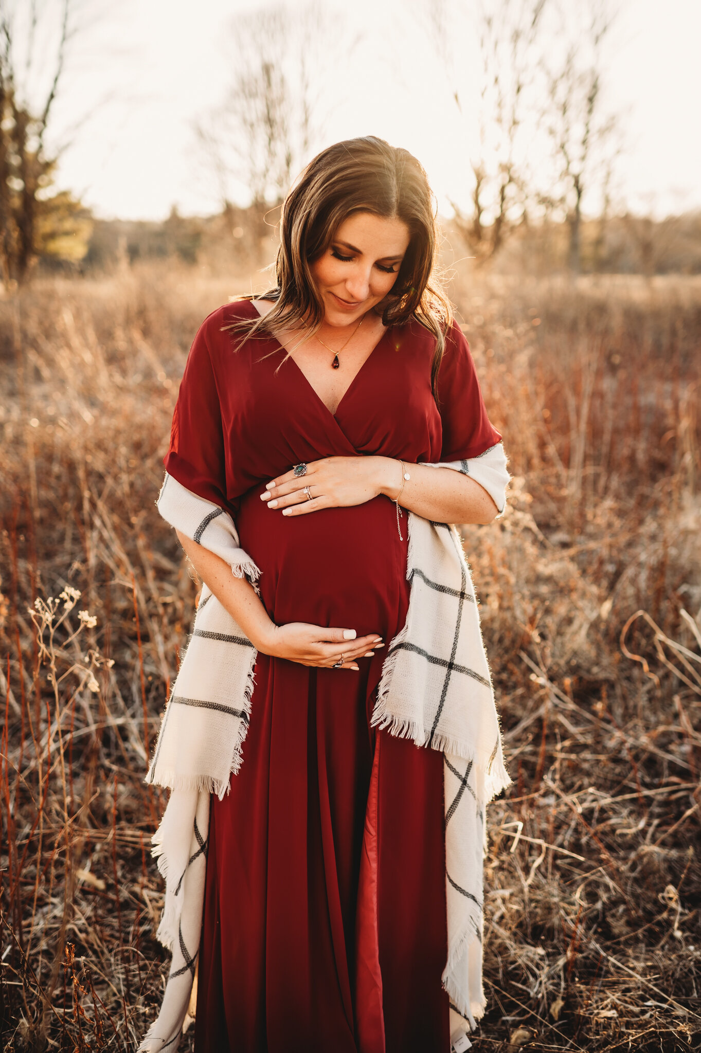Peoria IL maternity photographer, pregnant mom stands in field