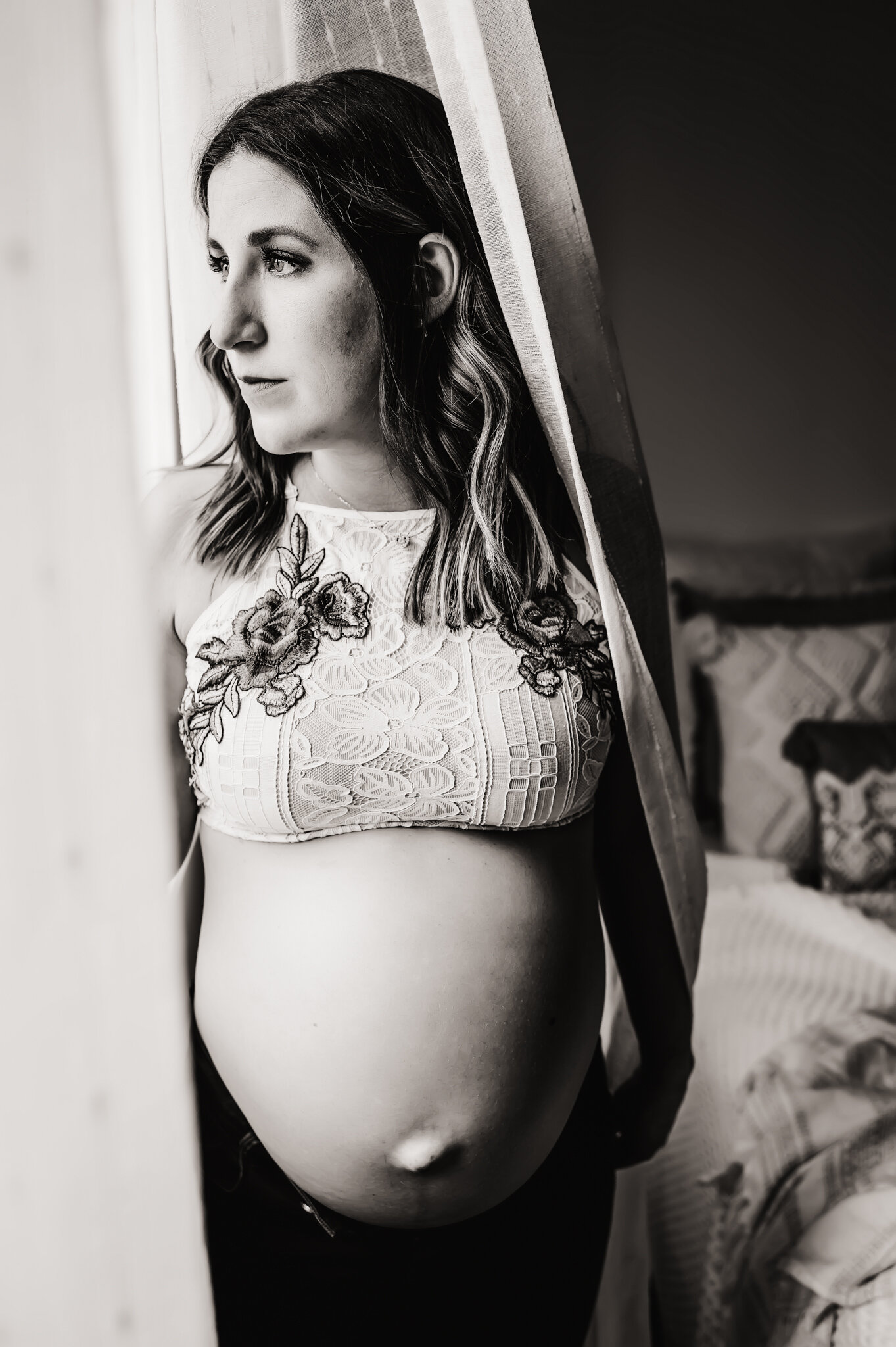 Black and white maternity photo near window.jpg