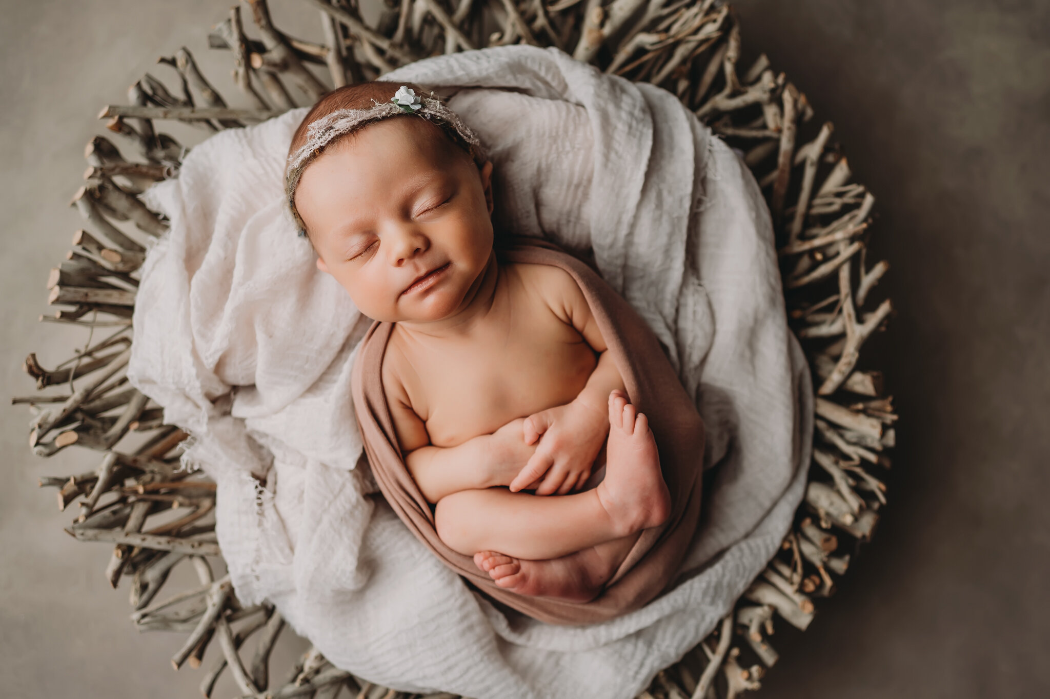 Newborn photo session baby lays in natural bowl.jpg