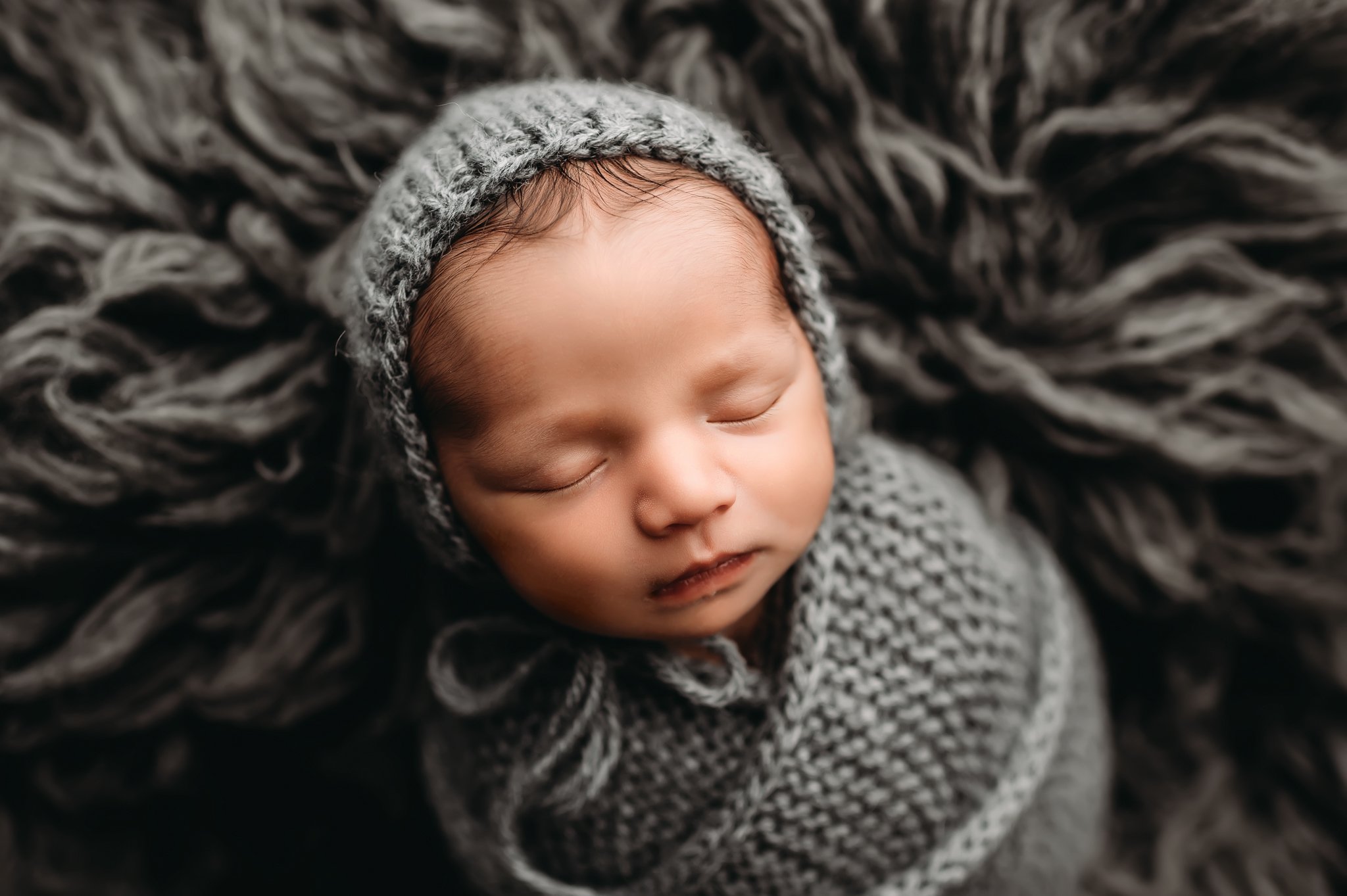 Newborn boy in bonnet.jpg