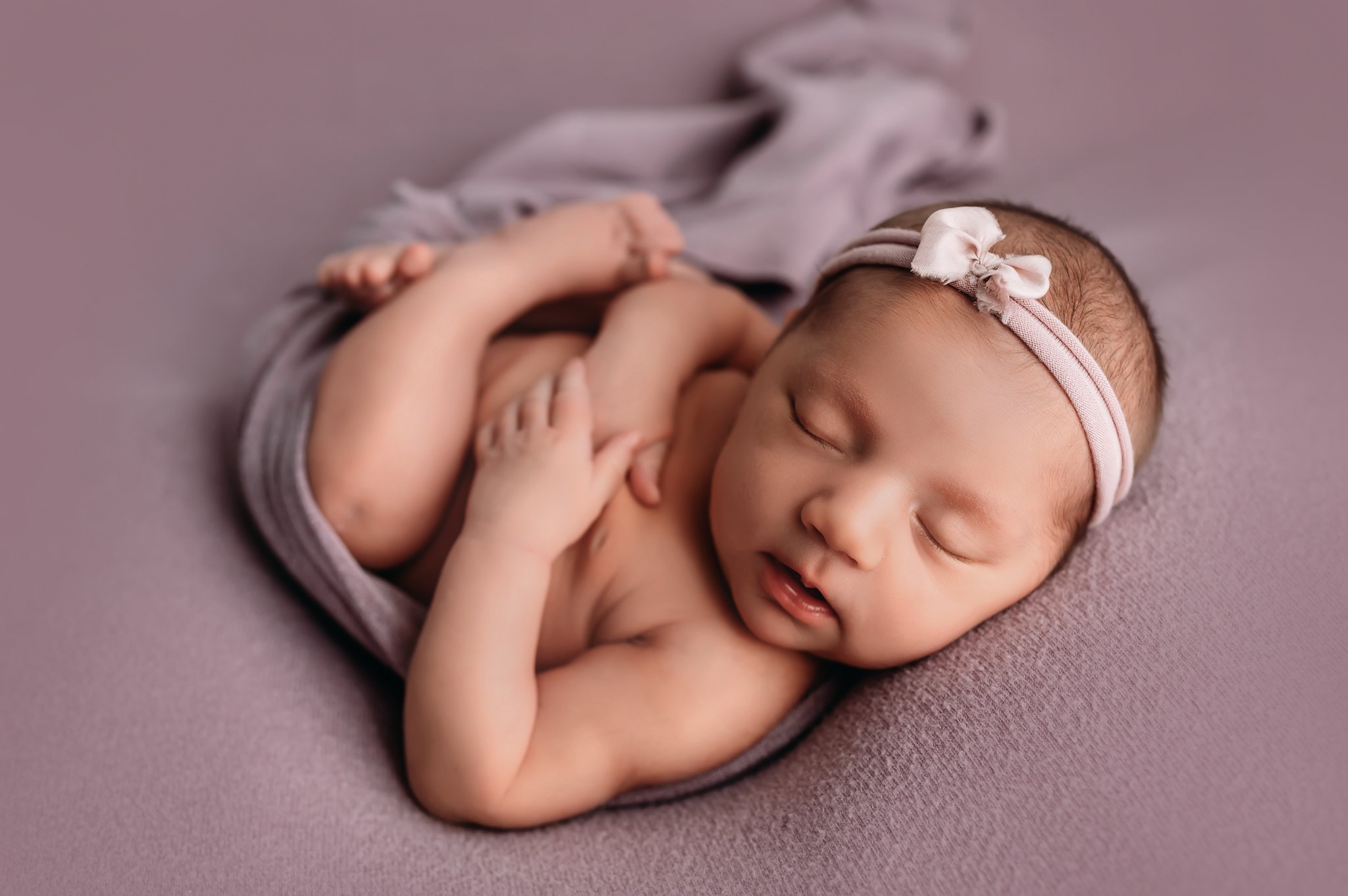 Newborn baby girl on purple.jpg