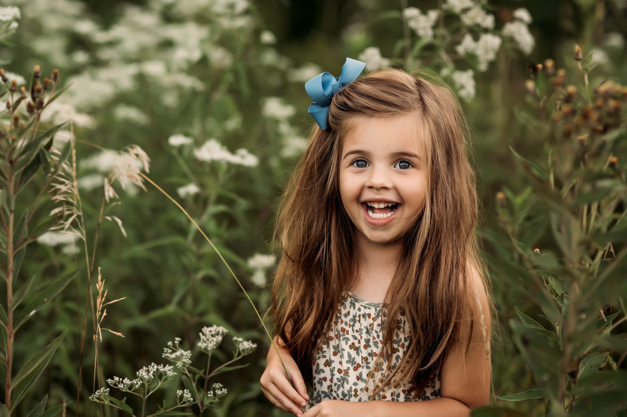 child in front of white flowers.jpg