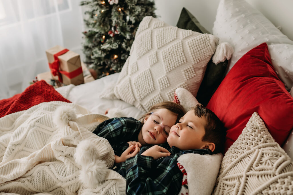 Brother and sister sleep in bed and wait for santa claus to come