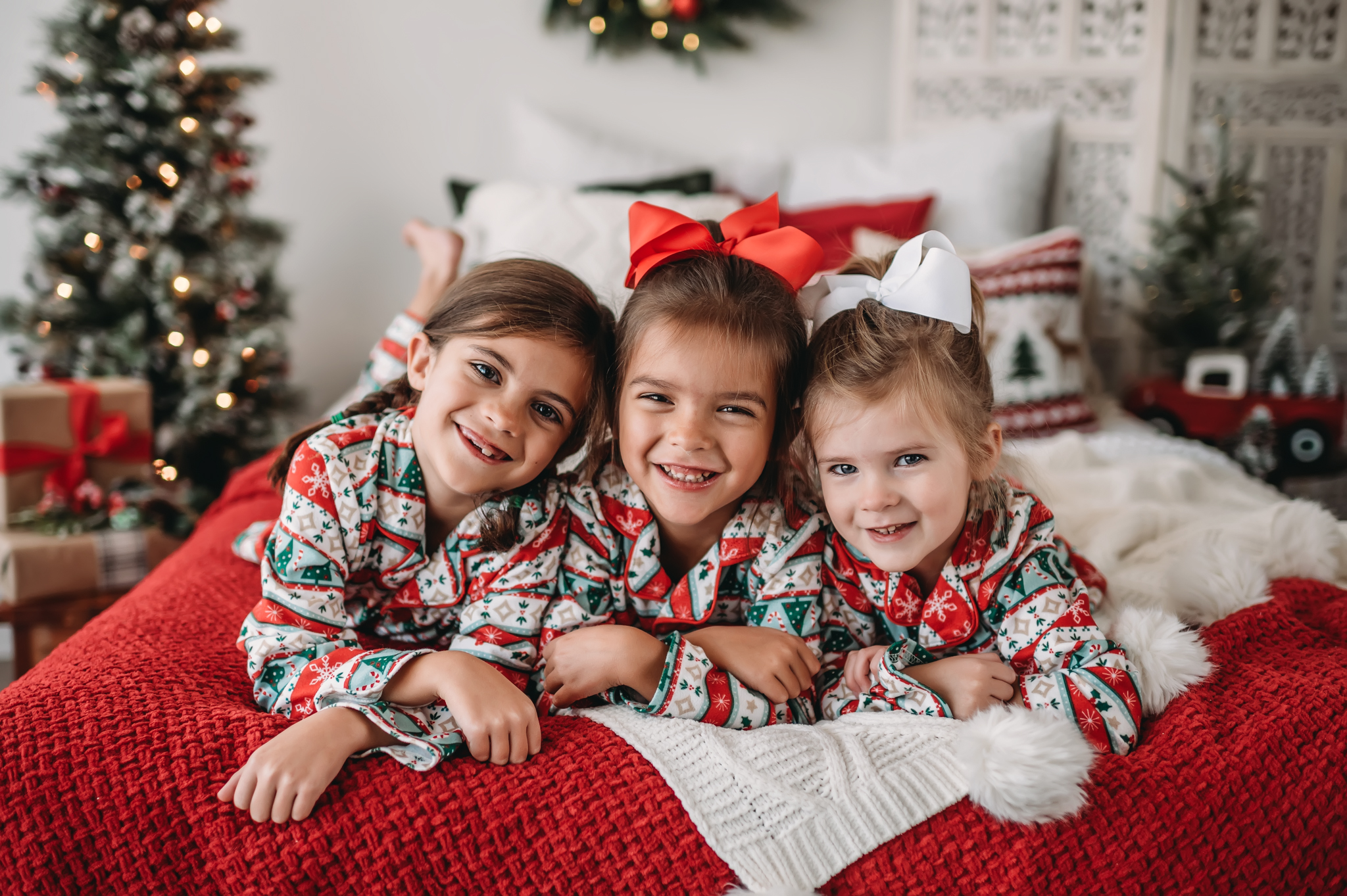 Three girls in Christmas Jammies lay together