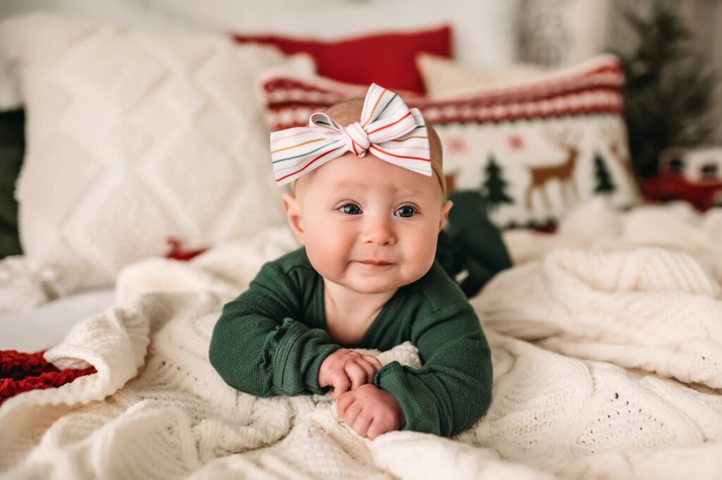 baby wears striped bow in Christmas colors
