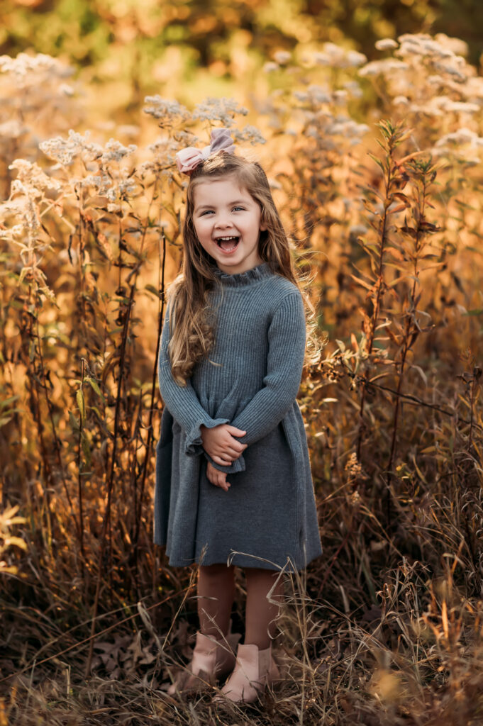 little girl laughs and poses