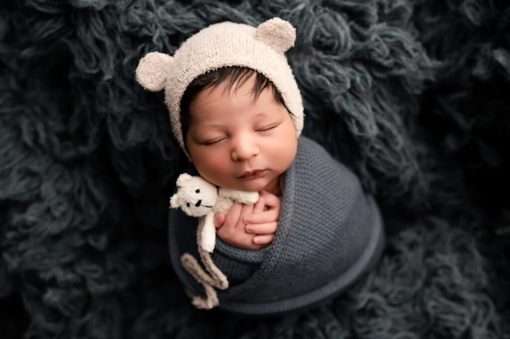 newborn baby holds teddy bear, newborn photos in peoria